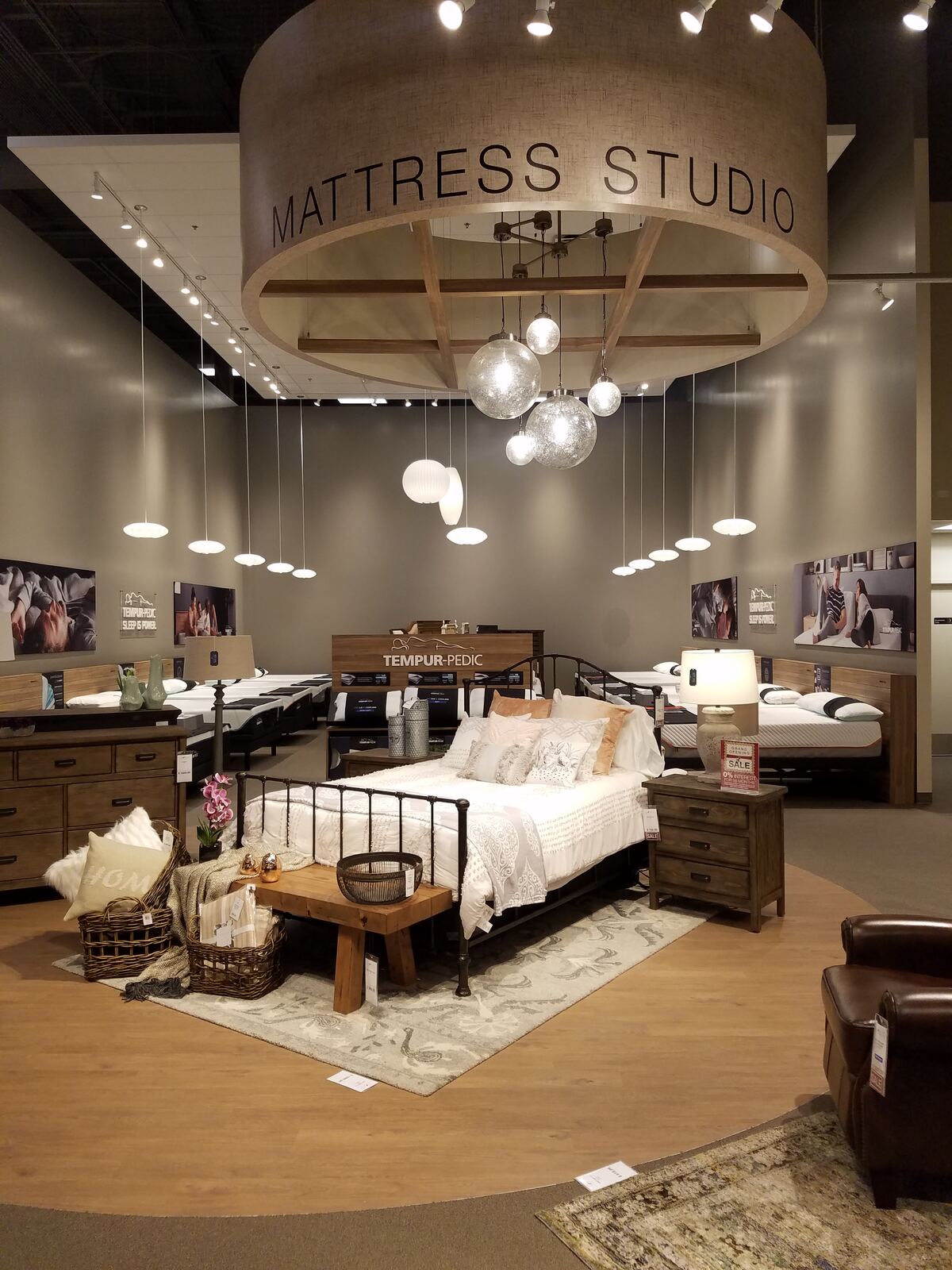 Mattress studio showroom with custom pendant lighting feature